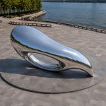 Aether Loop contemporary stainless steel abstract sculpture by FORMA Sculptures, featuring a fluid aerodynamic form that symbolizes movement, infinity, and the seamless connection between art, architecture, and nature.