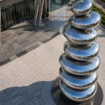 Equilibrium contemporary stainless steel architectural sculpture by FORMA Sculptures, featuring polished organic forms that create a landmark public art installation for luxury developments and urban spaces.