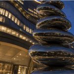 Equilibrium contemporary stainless steel architectural sculpture by FORMA Sculptures, featuring polished organic forms that create a landmark public art installation for luxury developments and urban spaces.