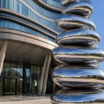 Equilibrium contemporary stainless steel architectural sculpture by FORMA Sculptures, featuring polished organic forms that create a landmark public art installation for luxury developments and urban spaces.