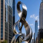 Infinity Nexus contemporary stainless steel architectural sculpture by FORMA Sculptures, featuring elegant flowing forms that create a landmark public art installation for luxury developments and urban skylines.