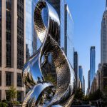 Infinity Nexus contemporary stainless steel architectural sculpture by FORMA Sculptures, featuring elegant flowing forms that create a landmark public art installation for luxury developments and urban skylines.