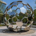 Nexus Sphere contemporary stainless steel geometric sphere sculpture by FORMA Sculptures, creating a landmark public art installation for urban plazas, corporate campuses, and luxury developments.