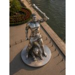 The Eternal Hero contemporary stainless steel monumental sculpture by FORMA Sculptures, depicting a mythical warrior with a lion, creating an iconic public art landmark for cities, parks, and cultural destinations.