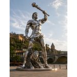 The Eternal Hero contemporary stainless steel monumental sculpture by FORMA Sculptures, depicting a mythical warrior with a lion, creating an iconic public art landmark for cities, parks, and cultural destinations.