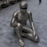 The Thinker contemporary stainless steel human sculpture by FORMA Sculptures, featuring an abstract figure crafted from typographic forms, creating a landmark public art installation for corporate, cultural, and urban environments.